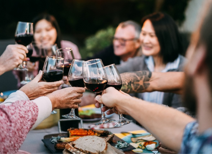 Ravel & Royale - Washington DC - Friends cheersing wine glasses at an outdoor dinner